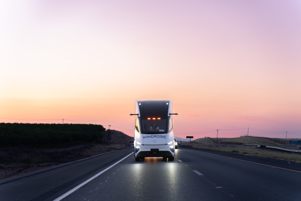 Windrose truck on highway at sunset