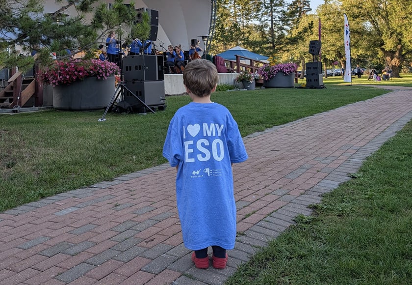 A child watching an ESO Outdoors concert in the park