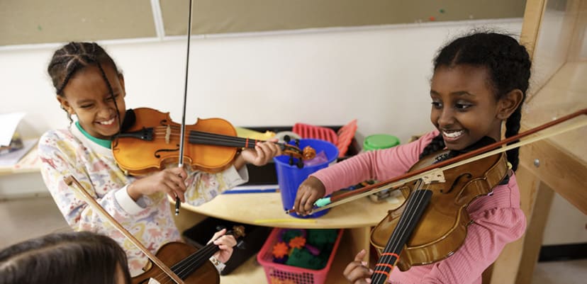YONA Students playing violins