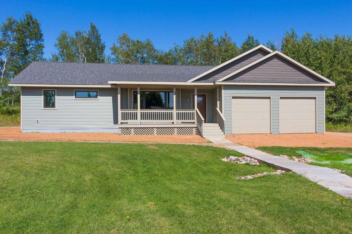 Light gray ranch-style modular home with covered front porch and two-car garage by Wisconsin Homes.