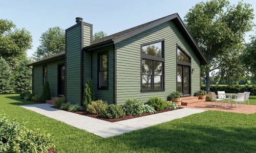 Dark green cottage-style modular home by Wisconsin Homes in Marshfield, WI with black trim and brick patio.