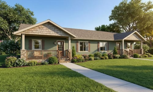 Green duplex modular home from Wisconsin Homes featuring two separate front porches with stone columns, brown shutters, symmetrical windows, and vibrant flower landscaping in a cottage-style setting.