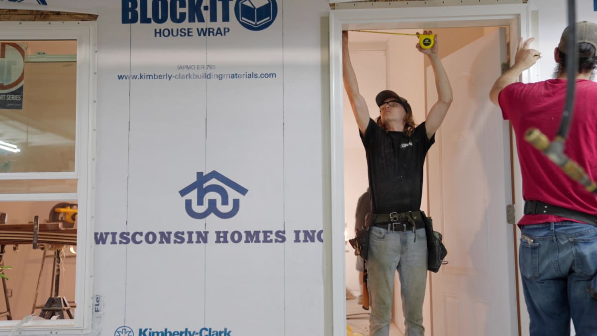 Wisconsin Homes representative discussing design samples with a customer inside the Marshfield, WI office.