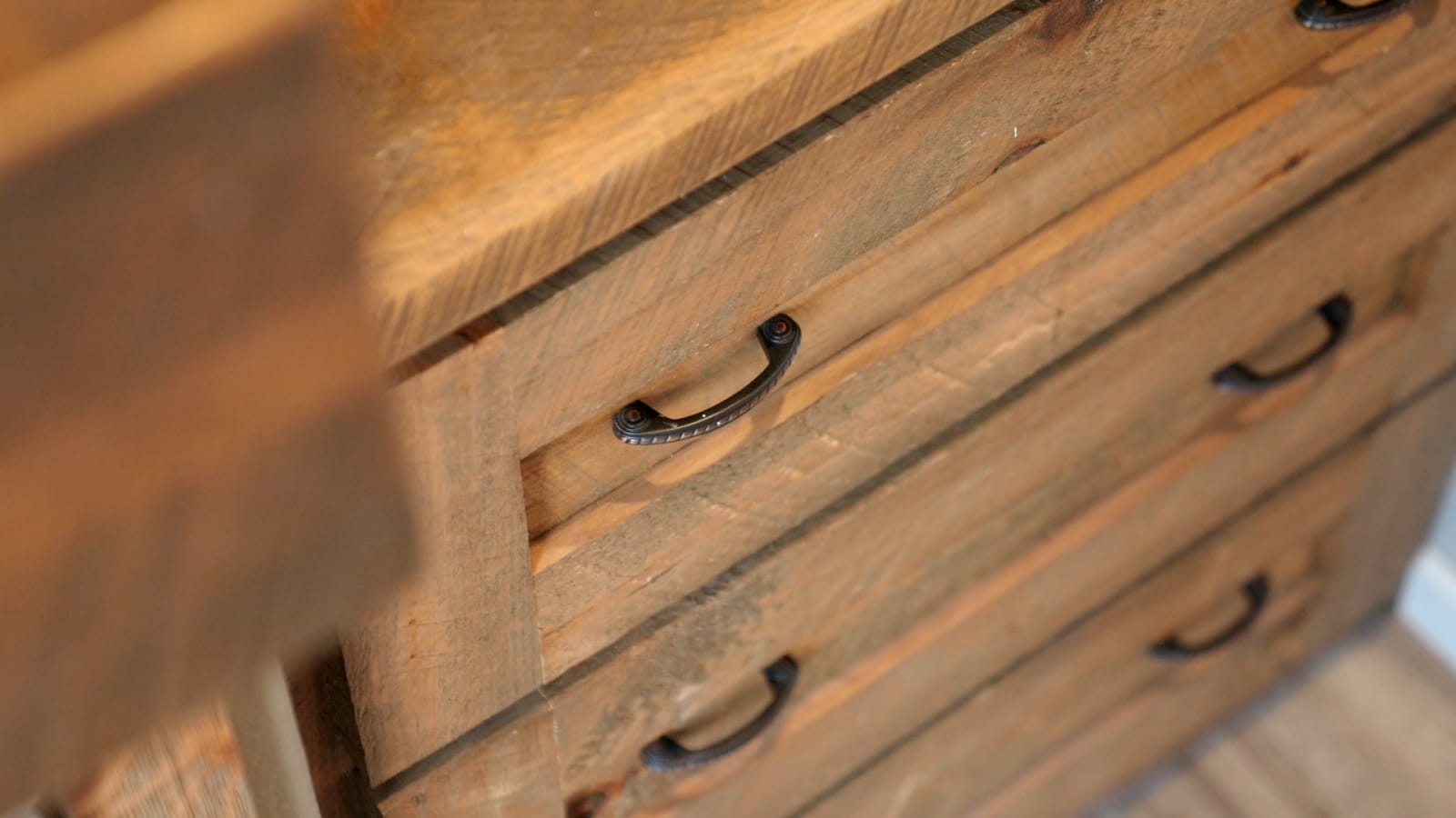 Custom wood kitchen cabinets by Wisconsin Homes with decorative glass inserts and modern black handles.
