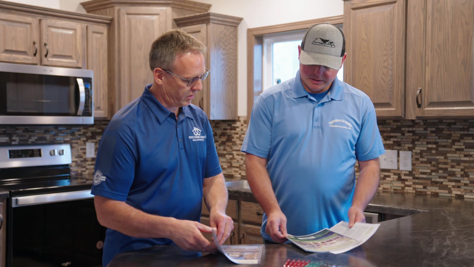 Wisconsin Homes representative reviewing floor plan books with centerville homes