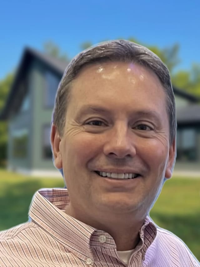 Wisconsin Homes team members smiling outside a finished modular model home in Marshfield, WI.