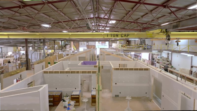 Modular home interiors under construction inside Wisconsin Homes' controlled manufacturing facility.