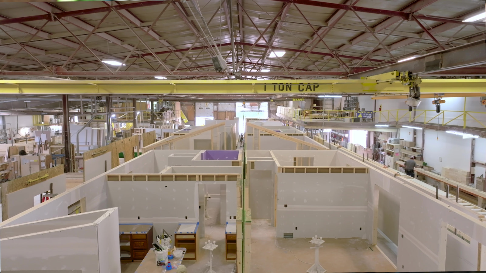 Modular home interiors under construction inside Wisconsin Homes' controlled manufacturing facility.