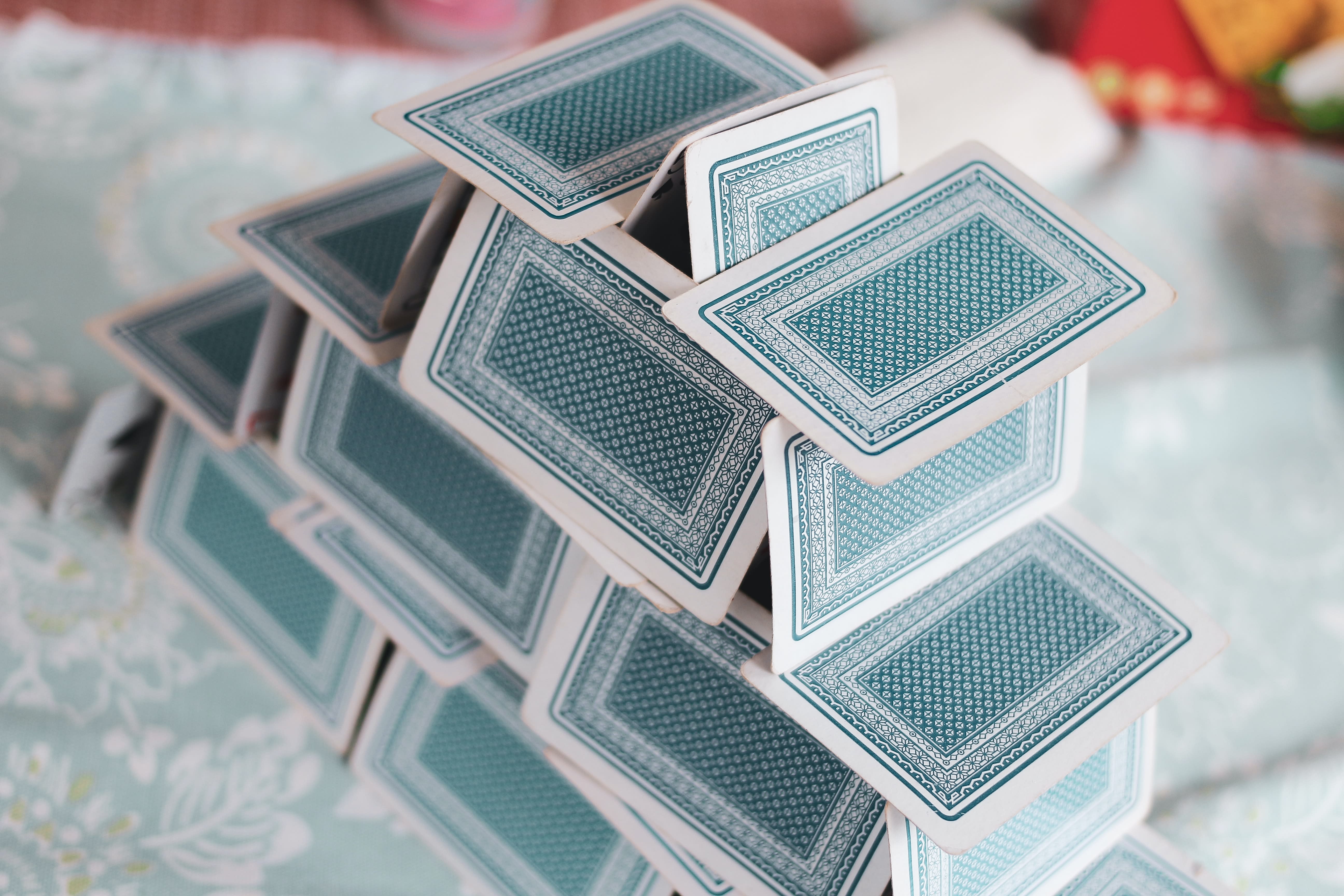 Playing cards stacked together to make a house of cards.