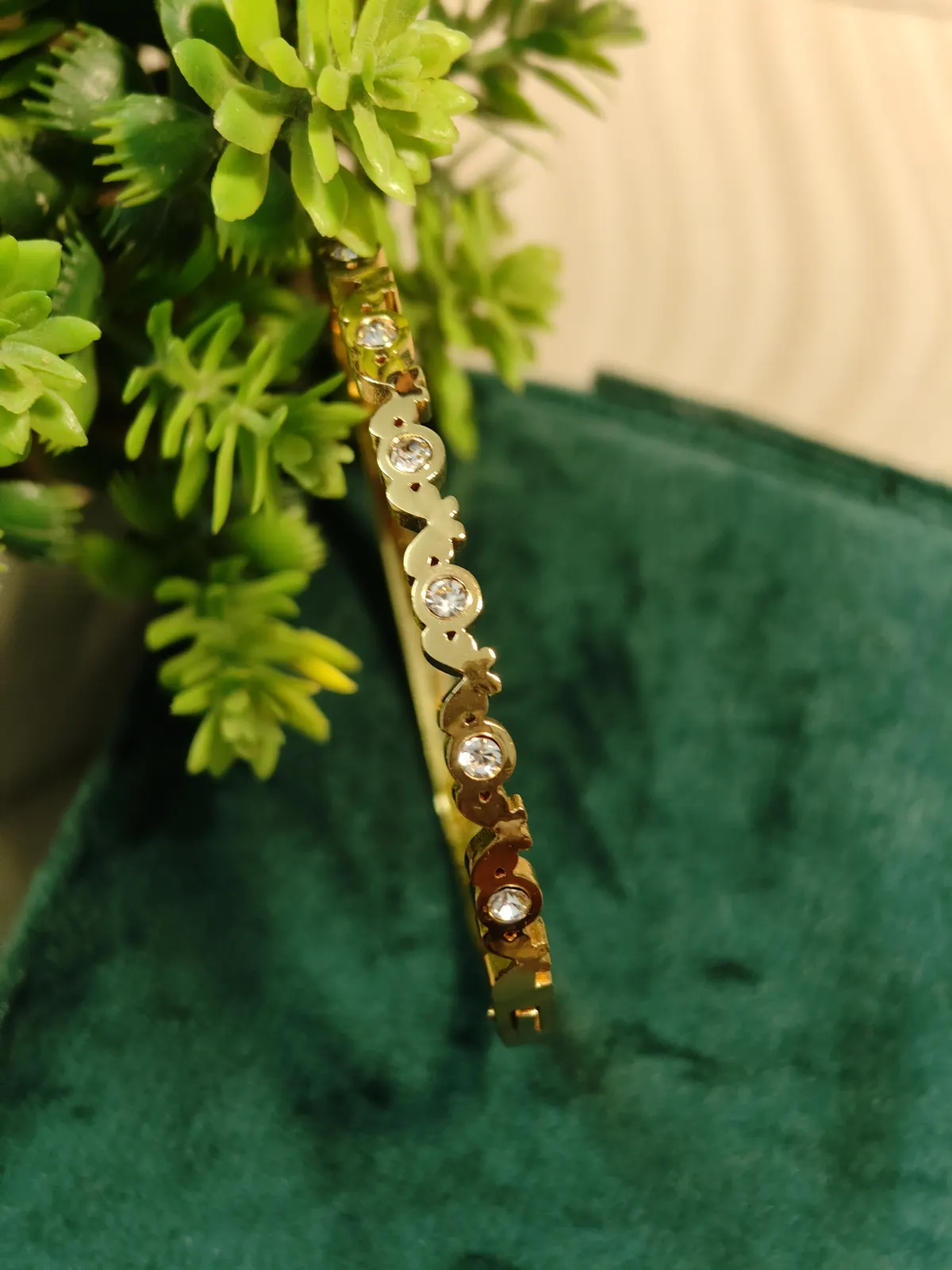 Gold Toned interlocking Butterfly shaped stoned Bangle