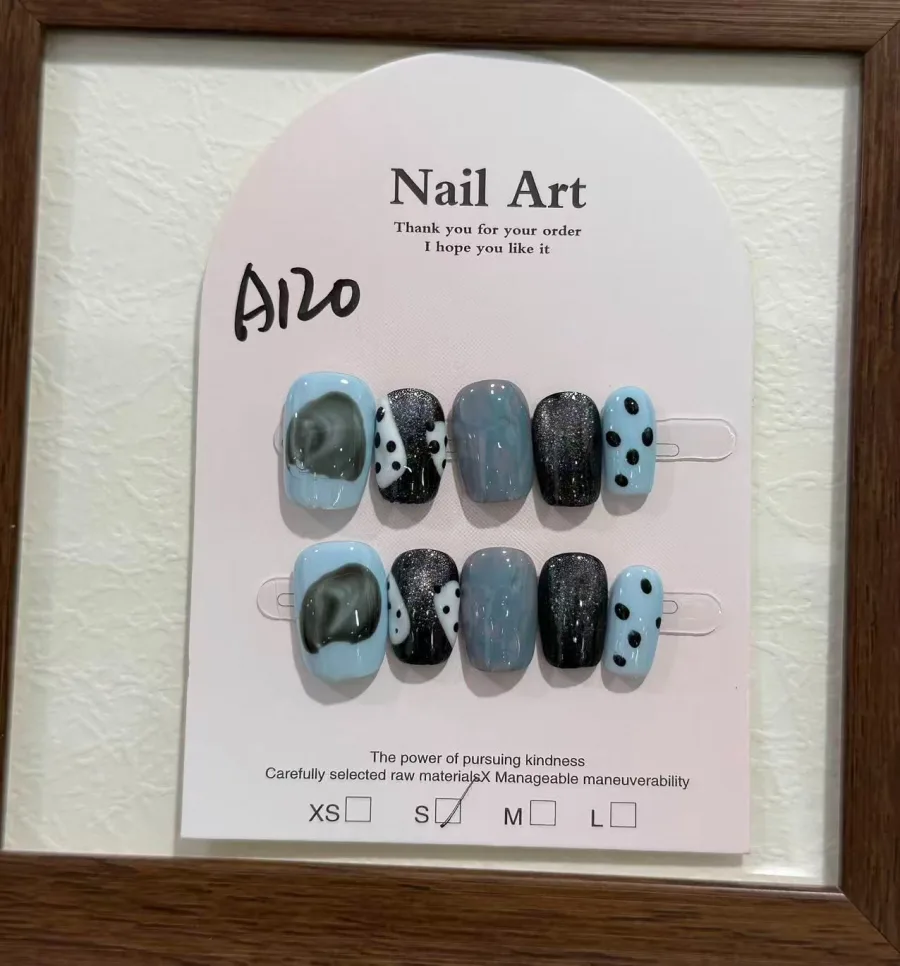 Cat-eye press-on nails with blue and black marbled effect