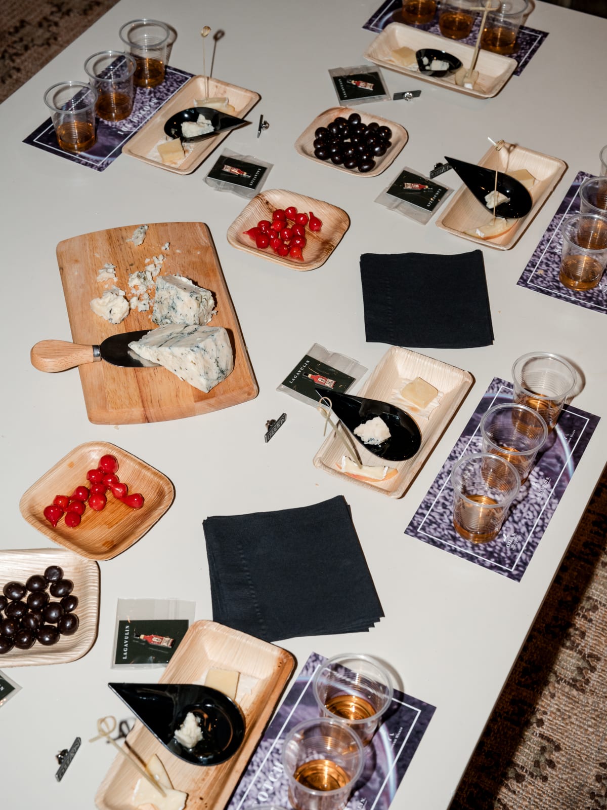 Oban tasting table set with drams, cheese, and olives