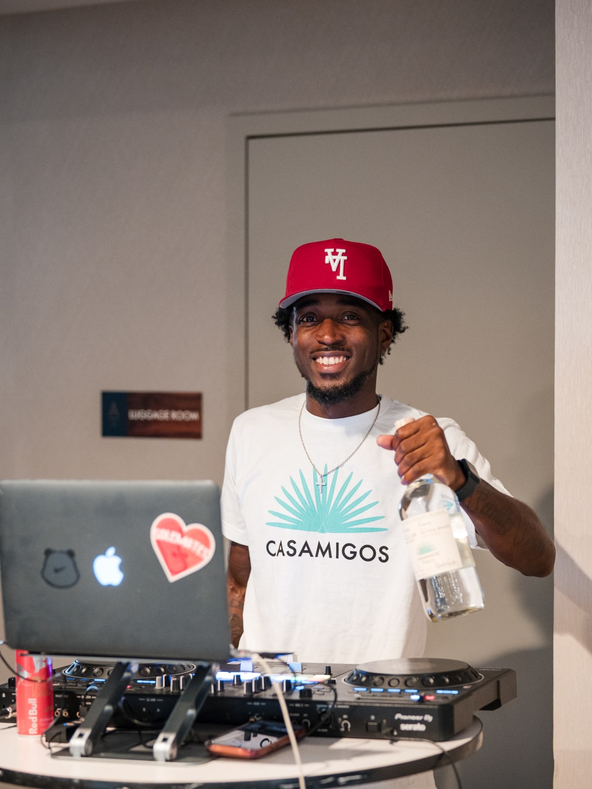 DJ in a Casamigos tee at the decks holding a cup