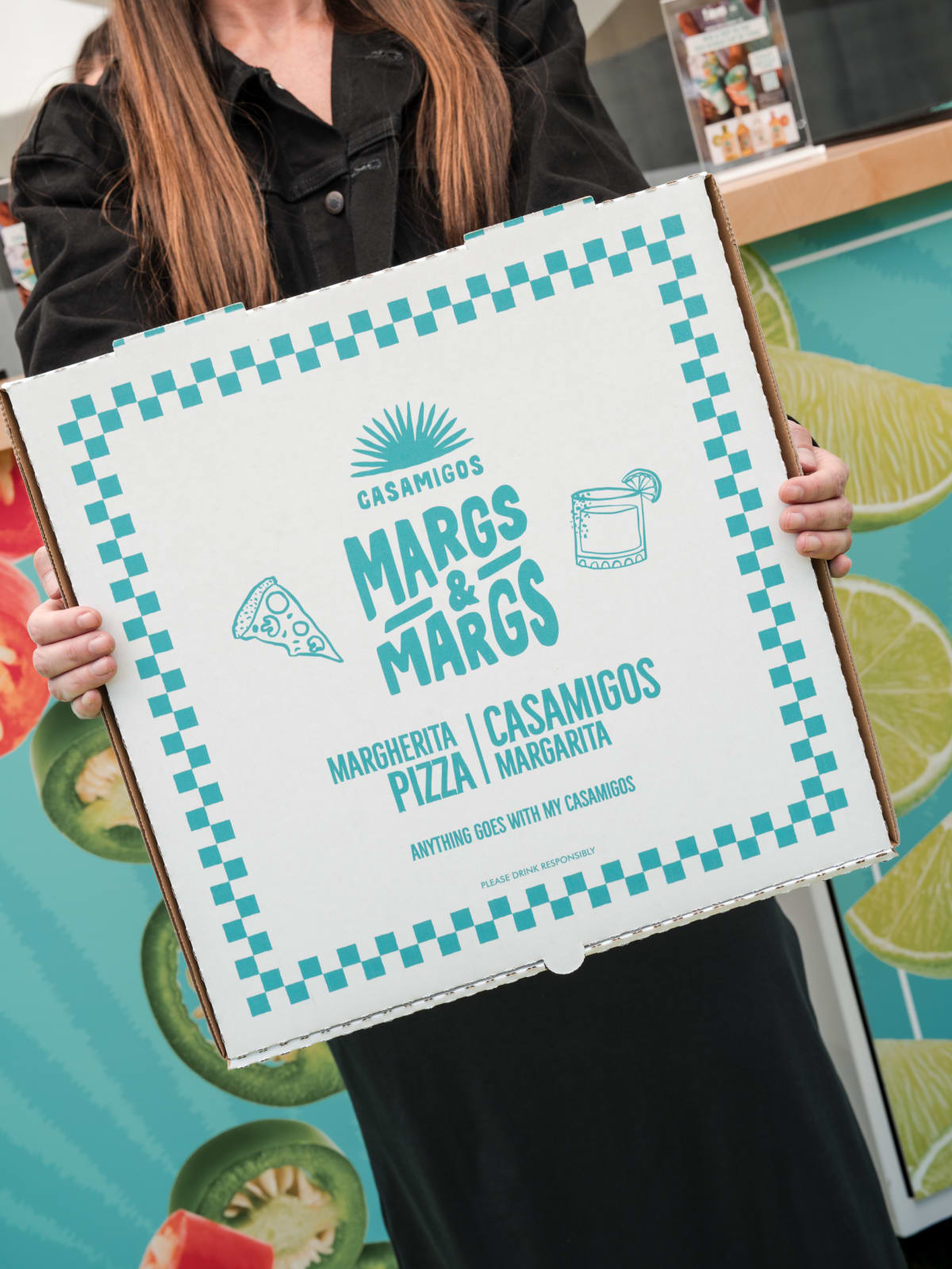 Hands holding a Margs & Margs pizza box