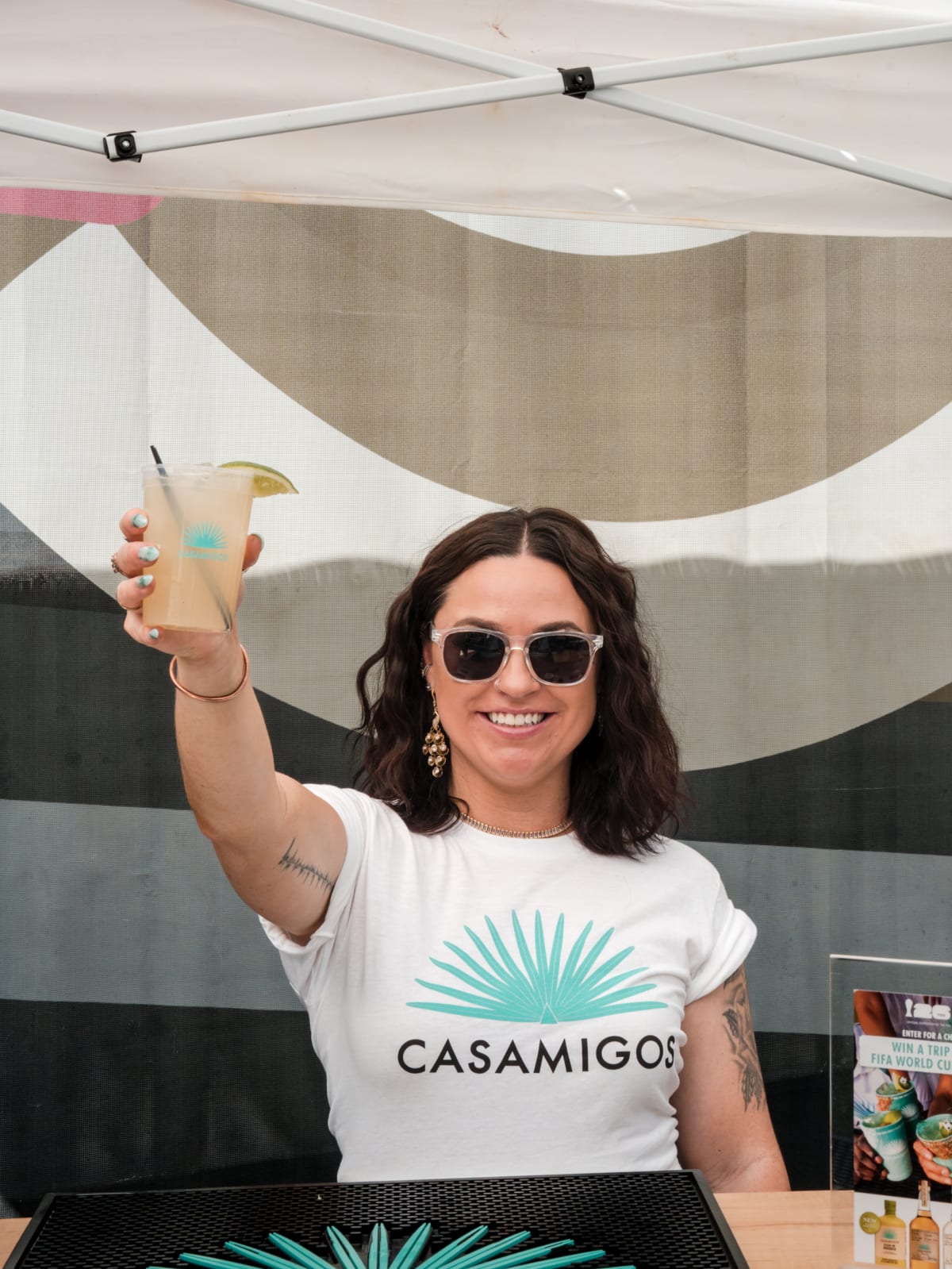 Brand ambassador in a Casamigos tee raising a margarita
