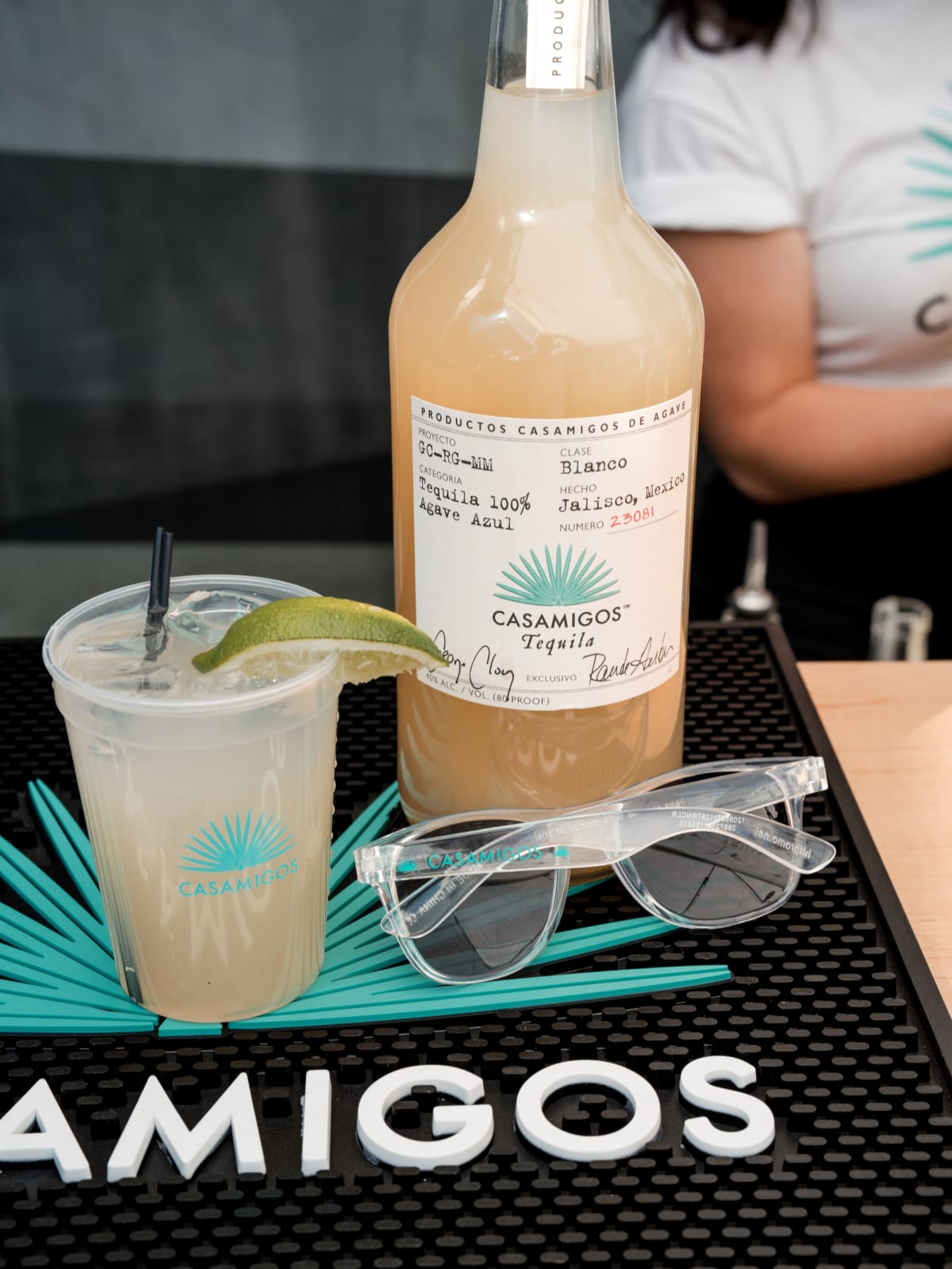 Batched margarita bottle and a served cup on the Casamigos bar mat