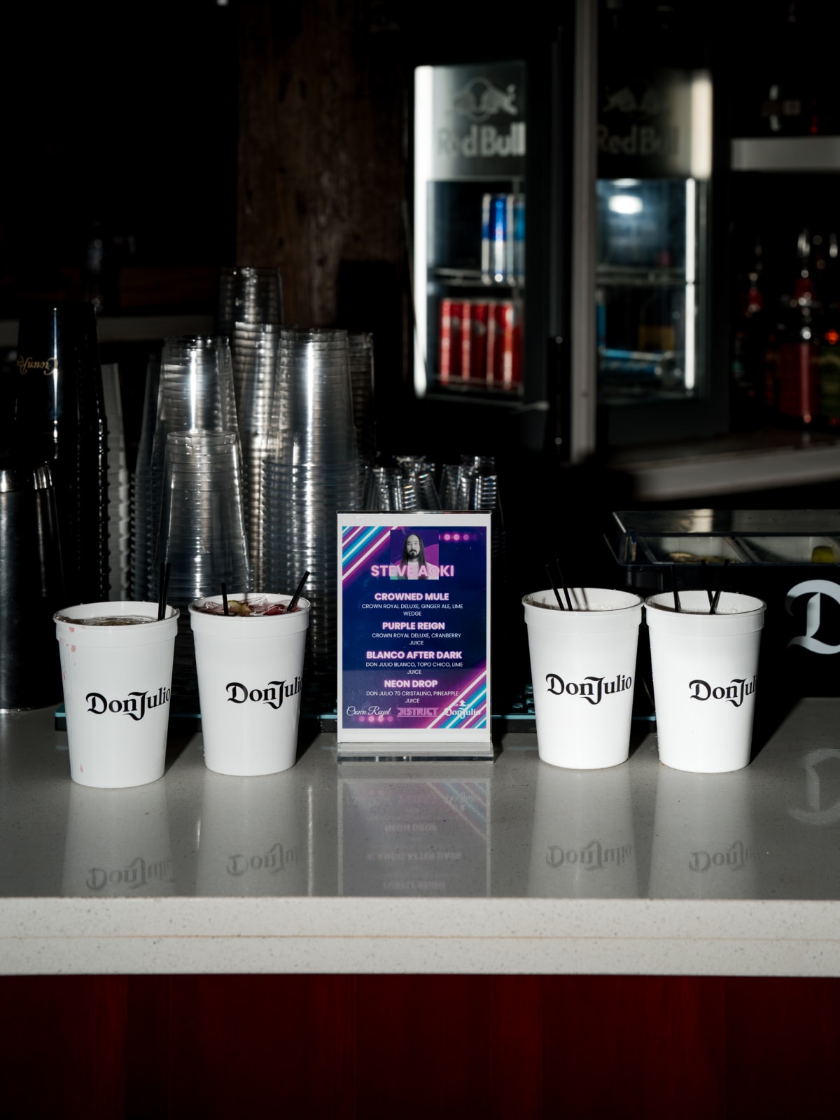 A row of branded Don Julio cups lined up on the bar