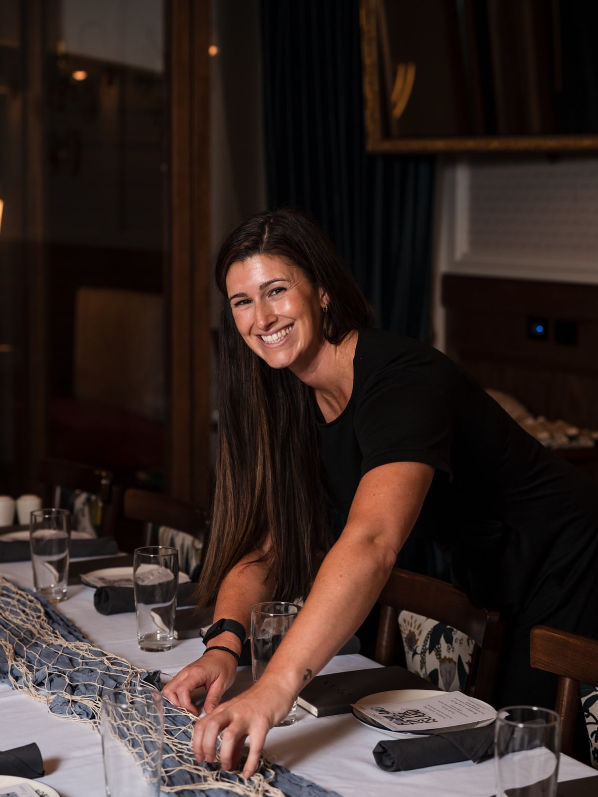Host seated at the head of the tasting table