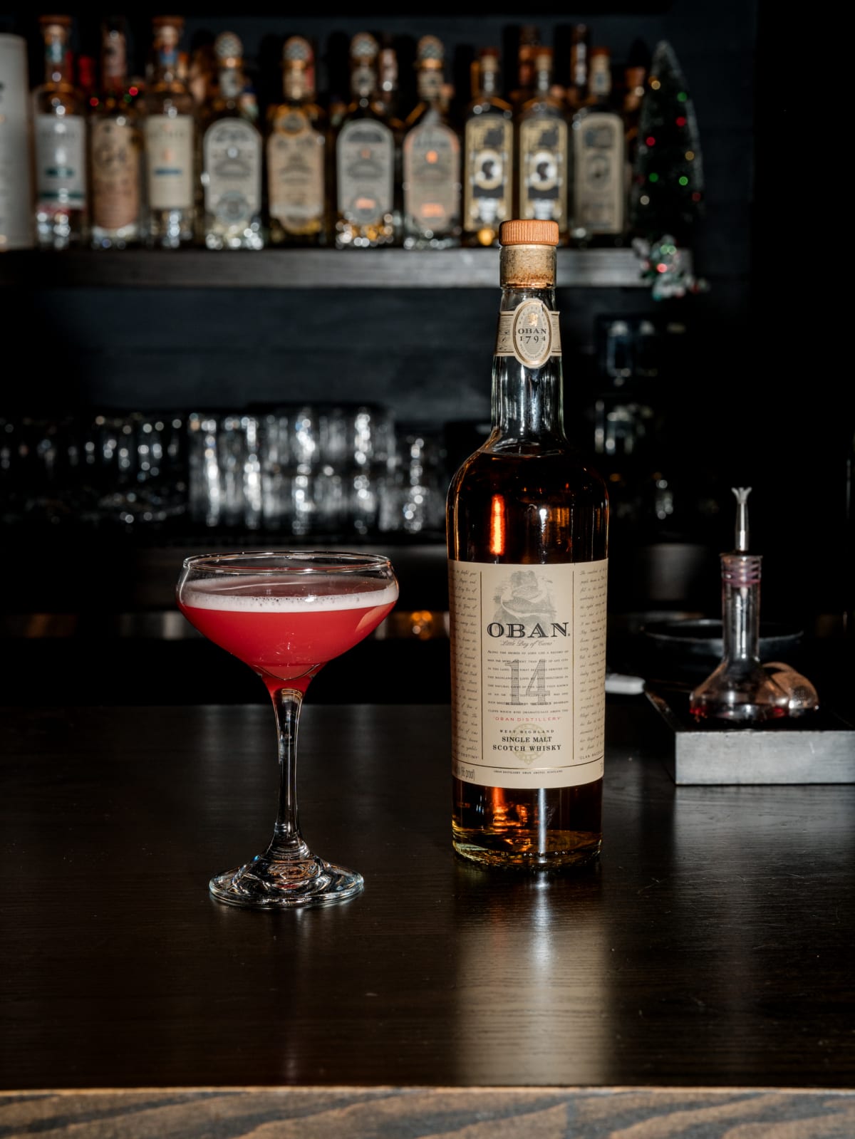 Oban 14 beside a coupe cocktail on the bar