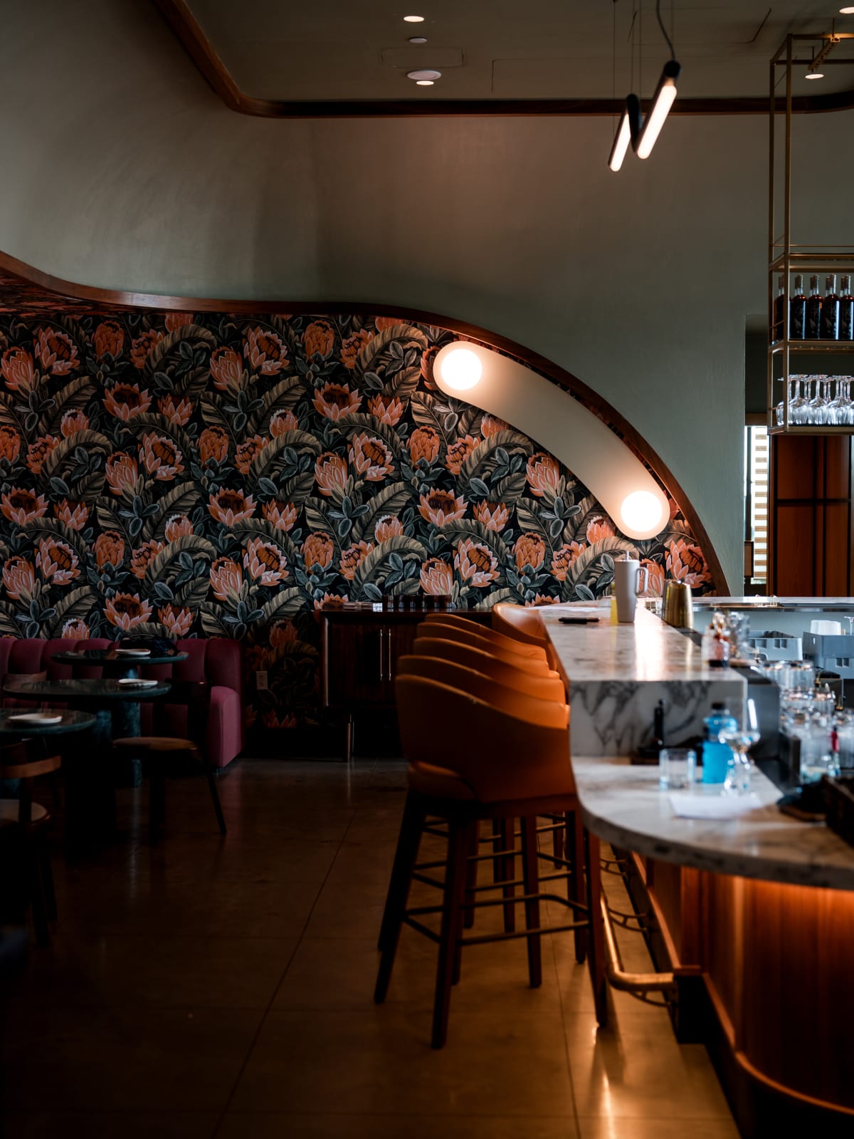 The curved bar against floral wallpaper