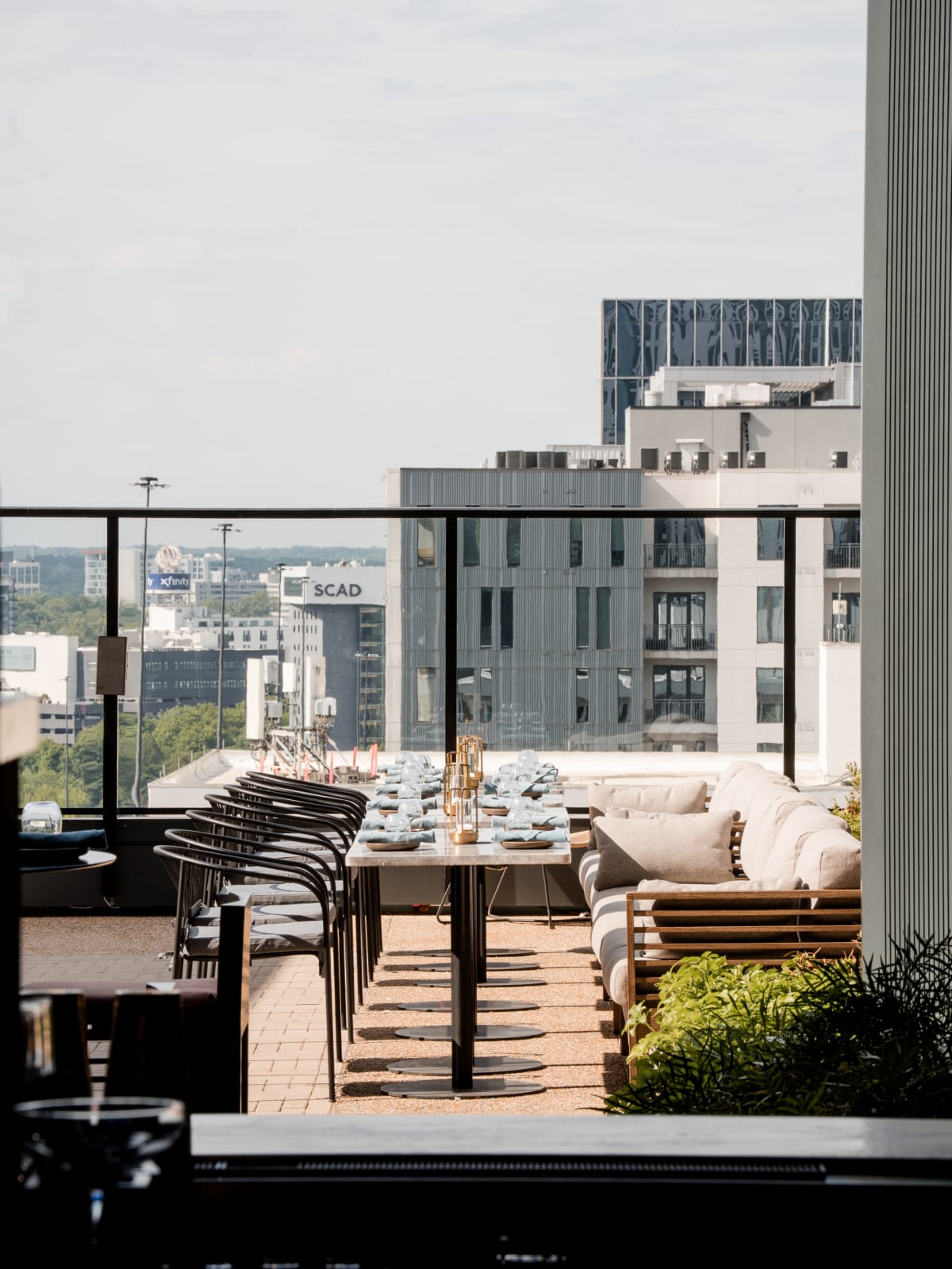 Rooftop terrace long table against the Atlanta skyline
