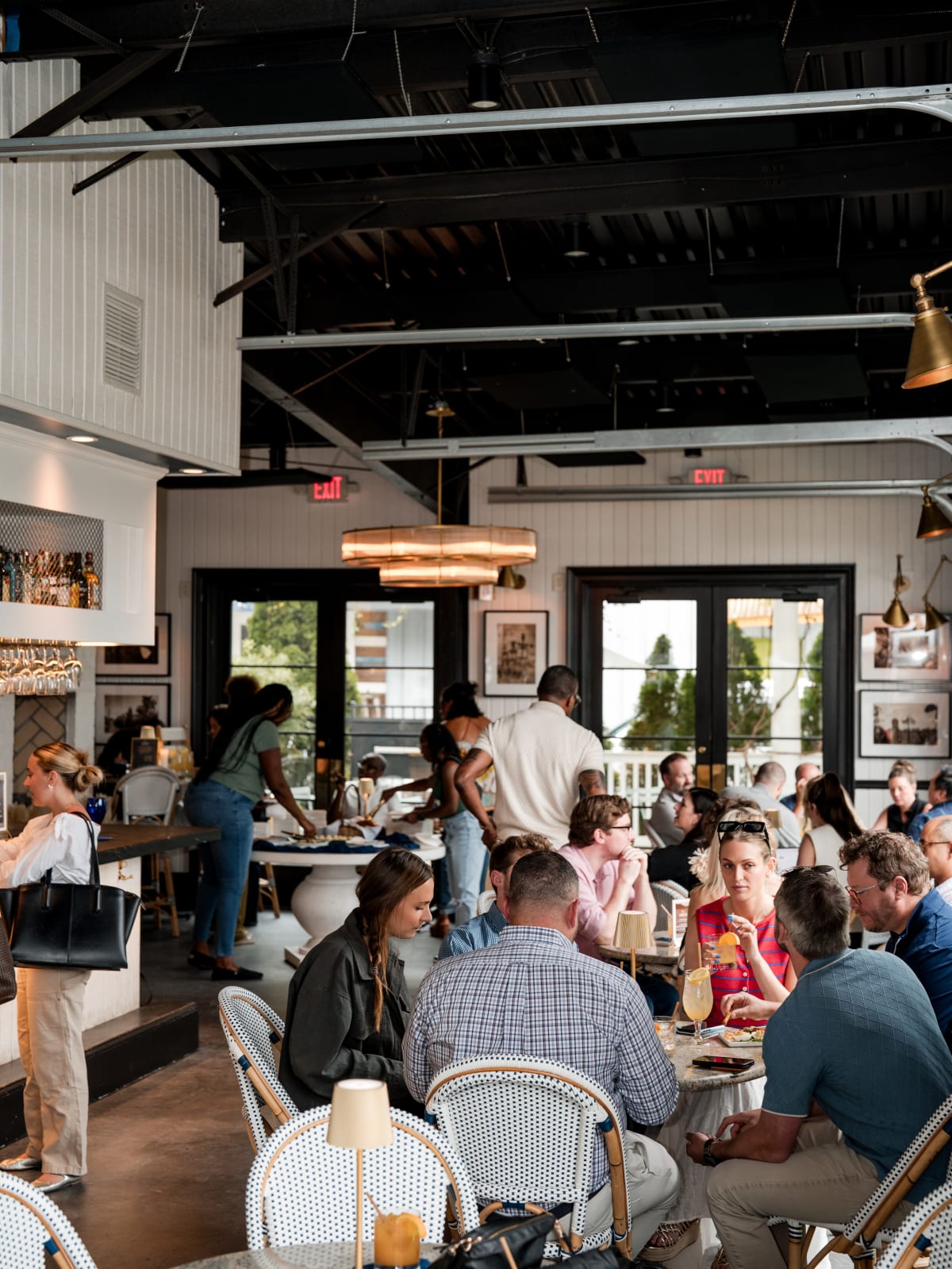 The dining room full of guests seated at cafe chairs
