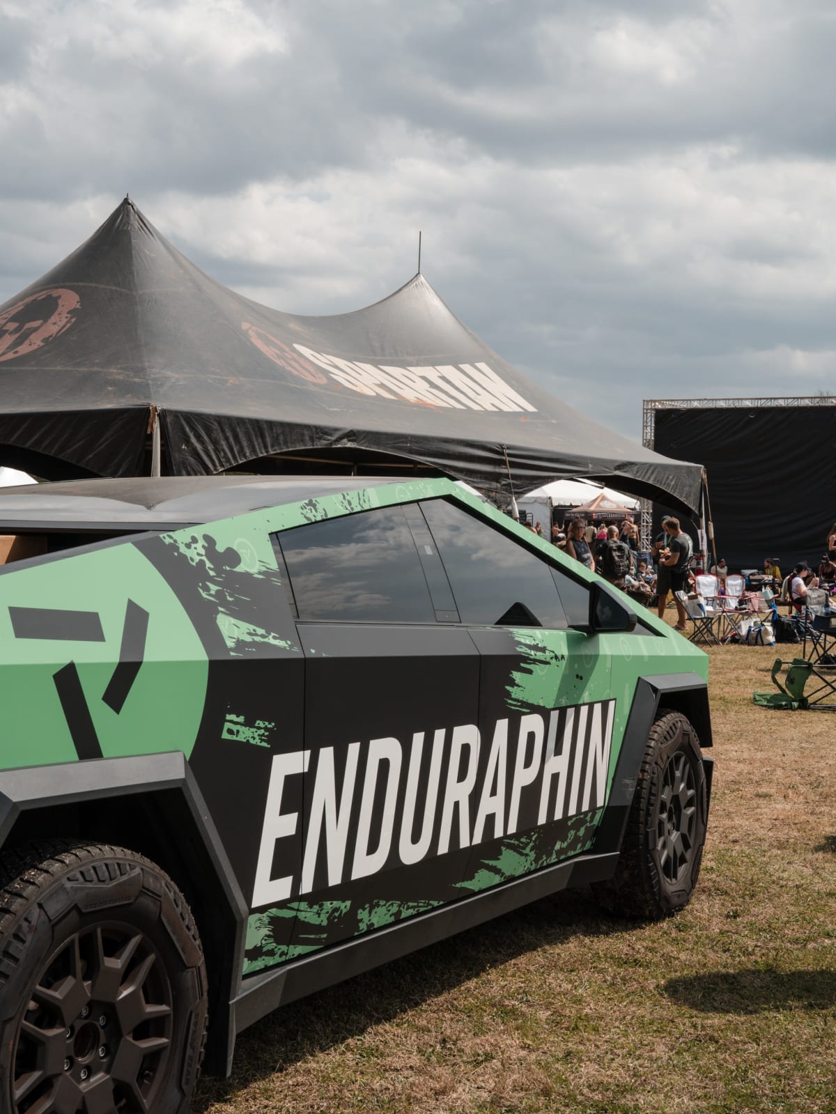 Truck and branded tent set up on the race field