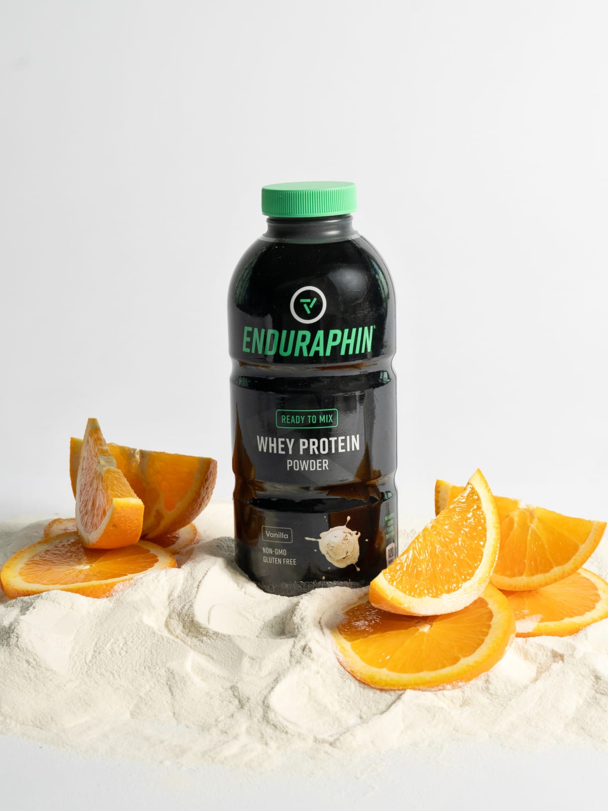 Orange slices and powder around the orange flavor bottle