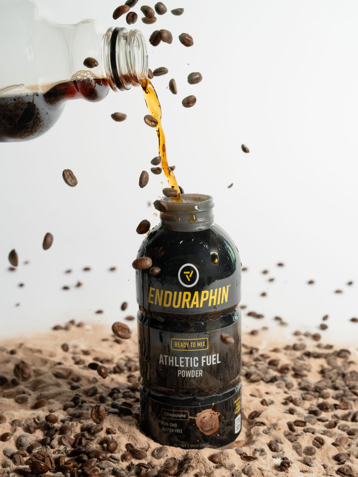 Enduraphin bottle poured over a bed of coffee beans