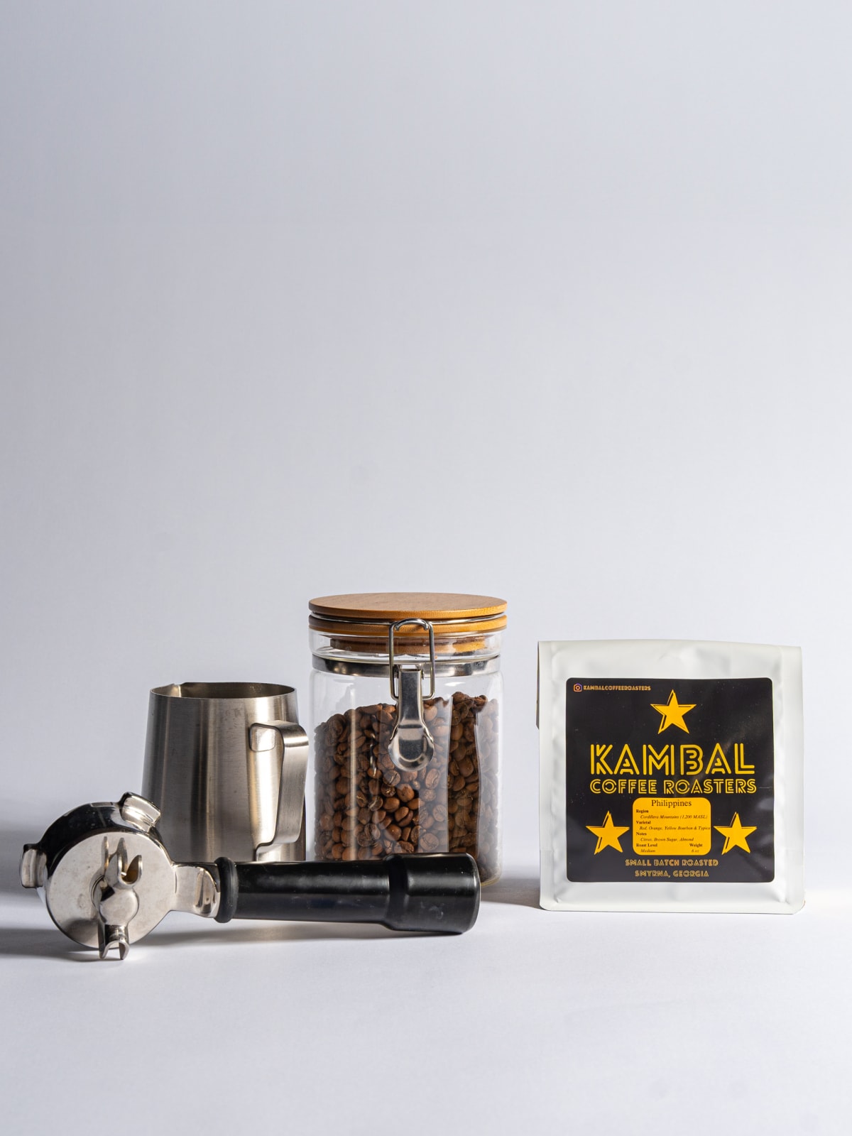 Kambal bag staged with an espresso portafilter and bean jar