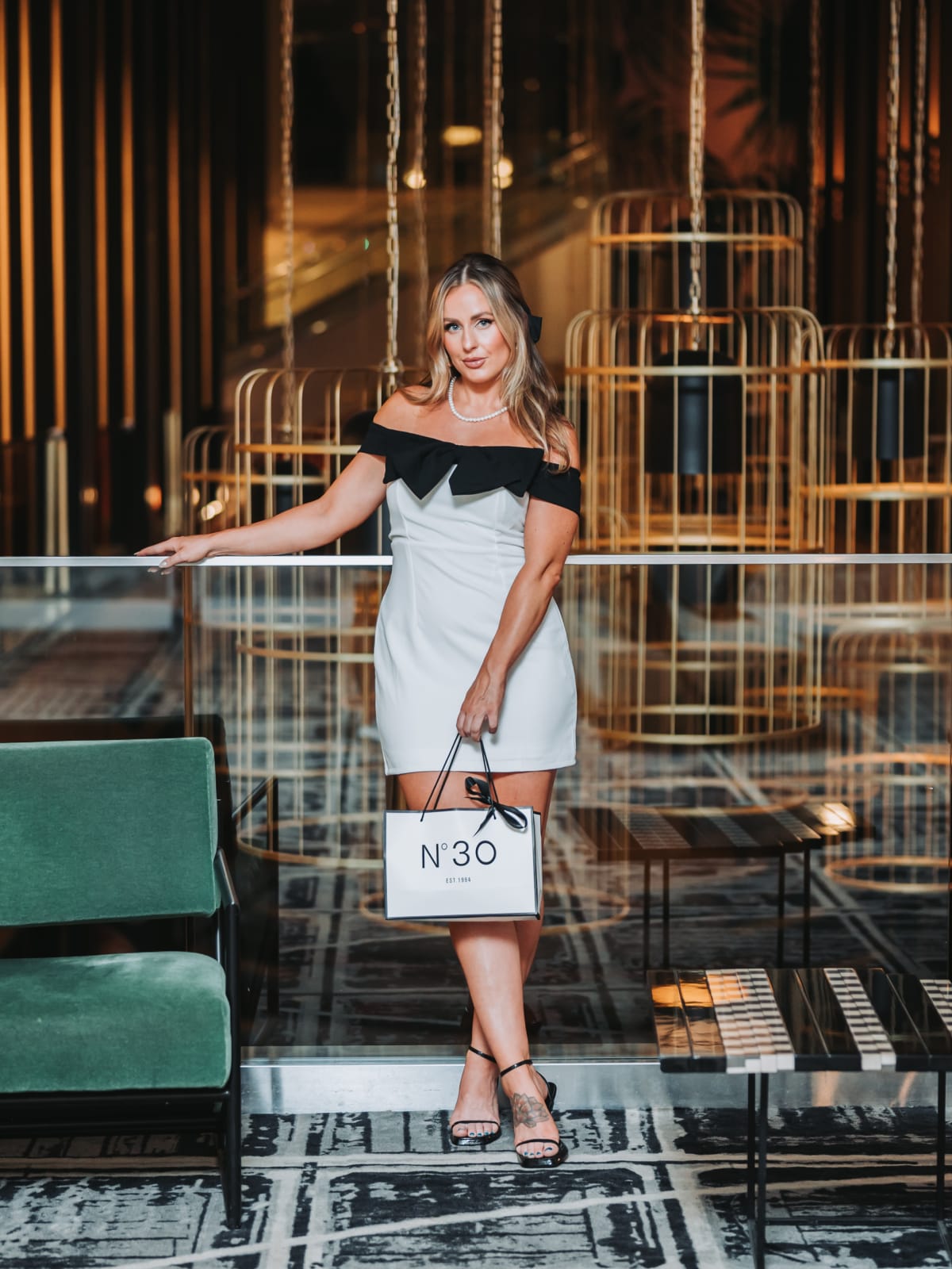 Thirtieth birthday portrait with a N°30 bag in a hotel lounge