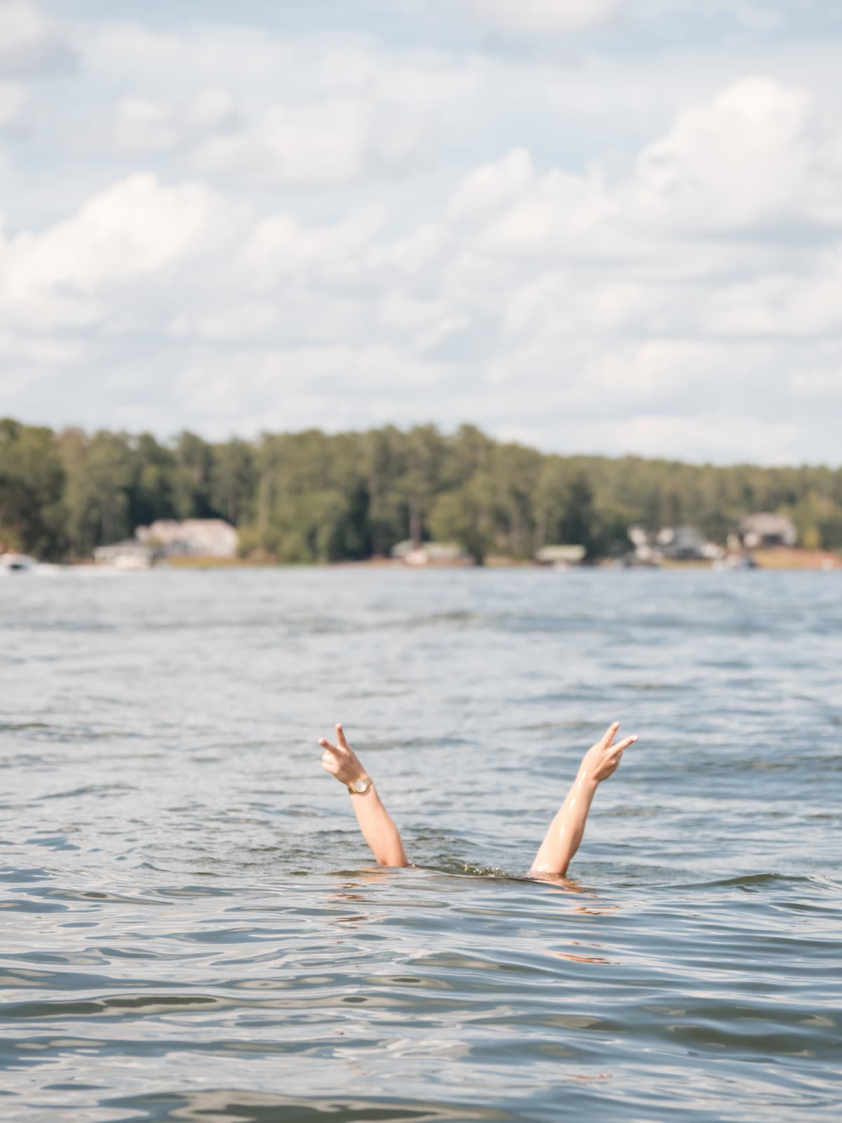 Two hands thrown up out of the water on Lake Sinclair