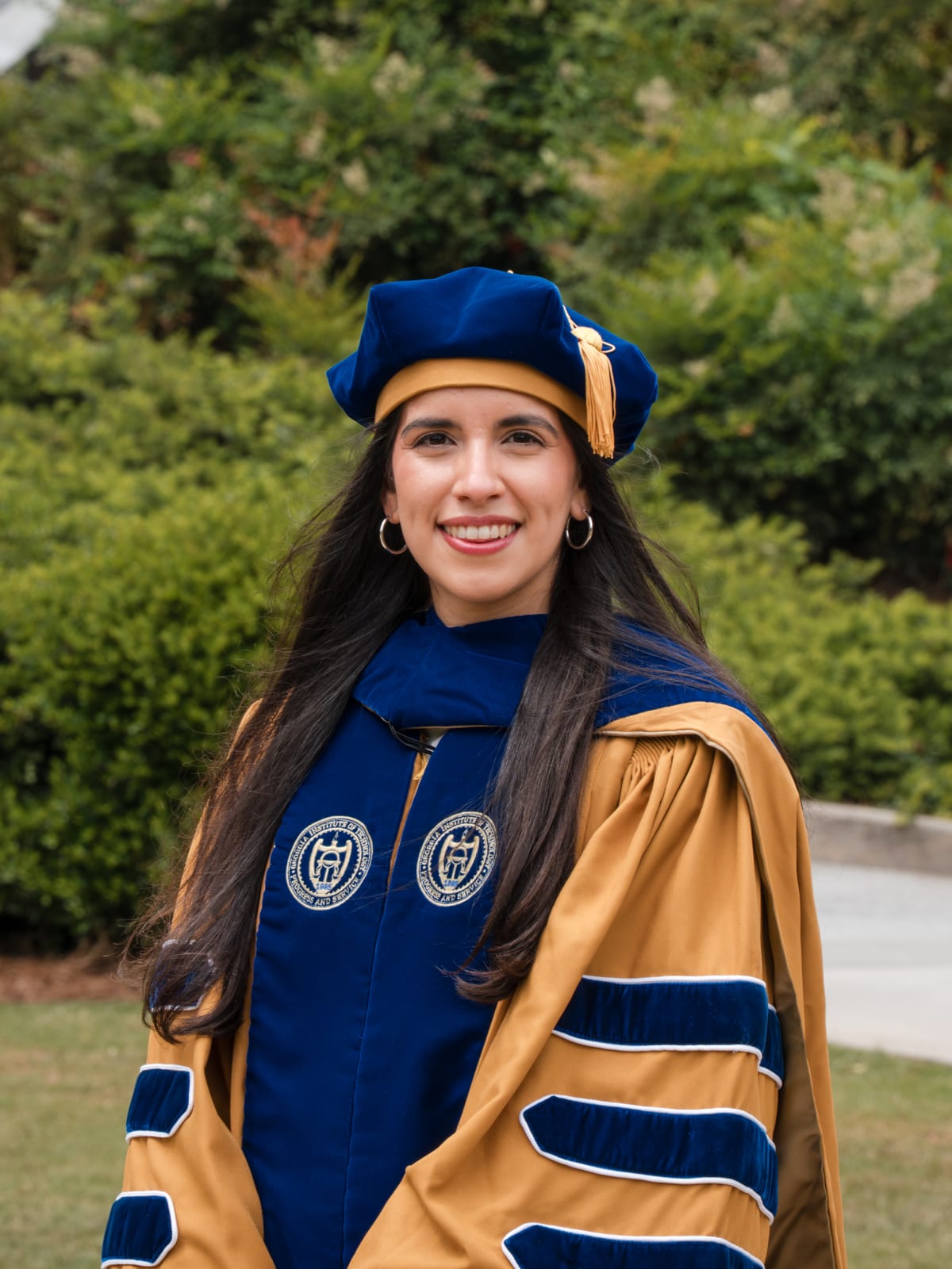 Graduation portrait with the Tech Tower behind