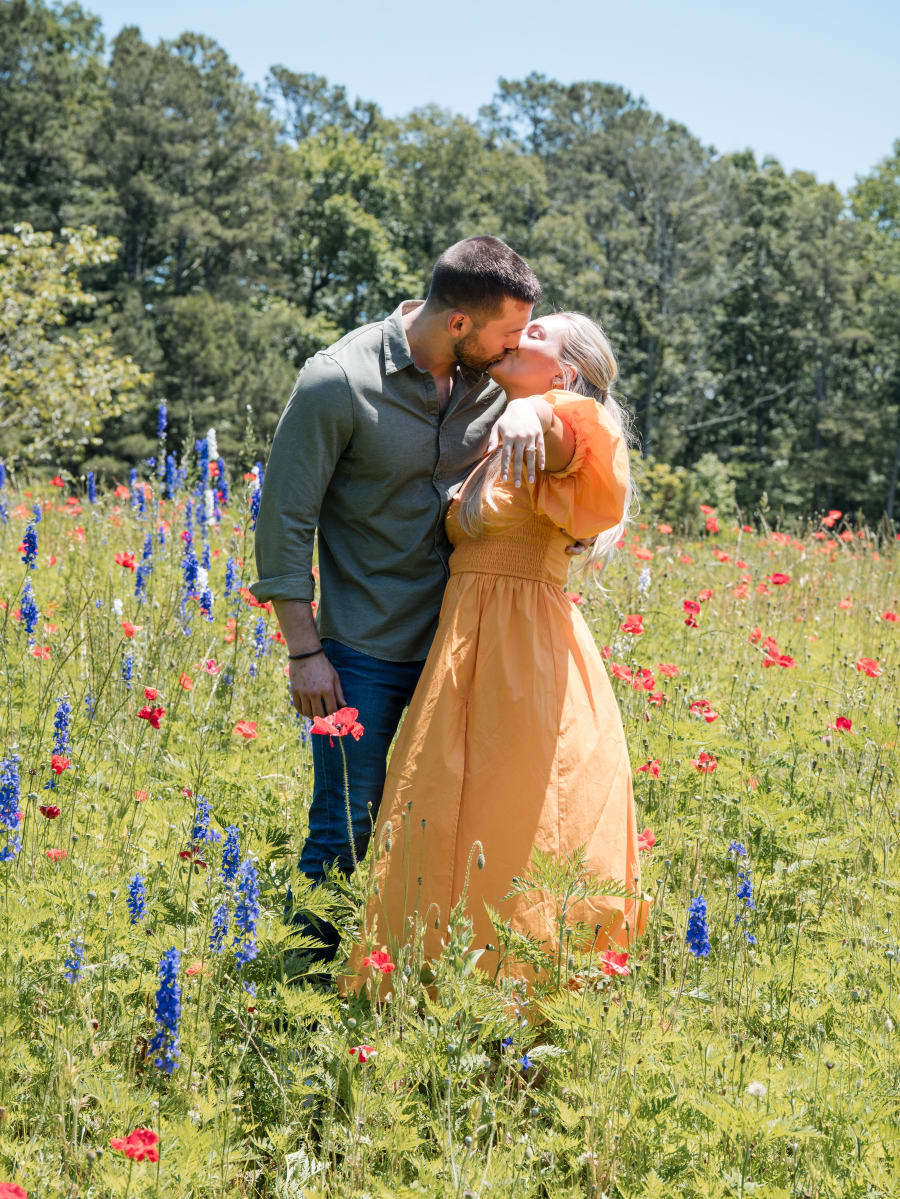 Kiss among the delphiniums and poppies