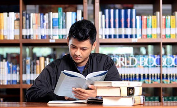Pria Pejuang Skripsi Membaca Buku di Perpustakaan