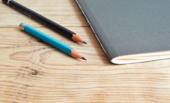 Two pencils and book