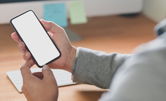 photo of a man using smartphone