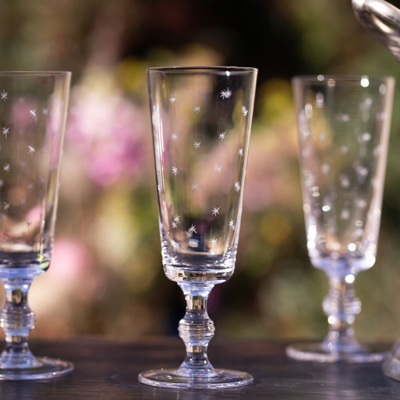 A Set Of Four Champagne Flutes With Stars Design image