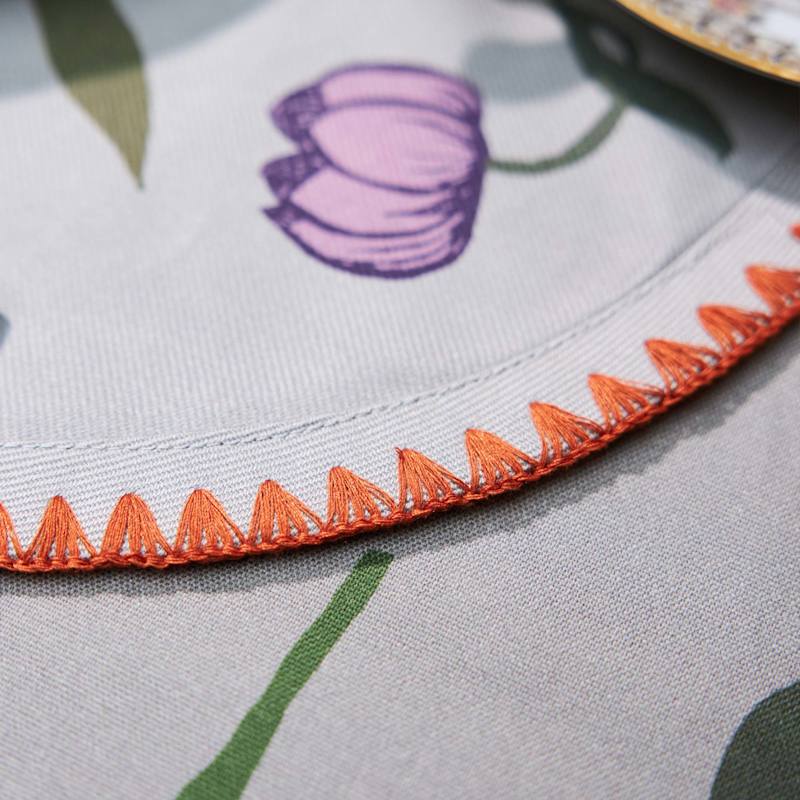 Thumbnail of Set Of Six Round Placemats In Oversize Bold Flower Print On Light Grey With Orange Embroidery image