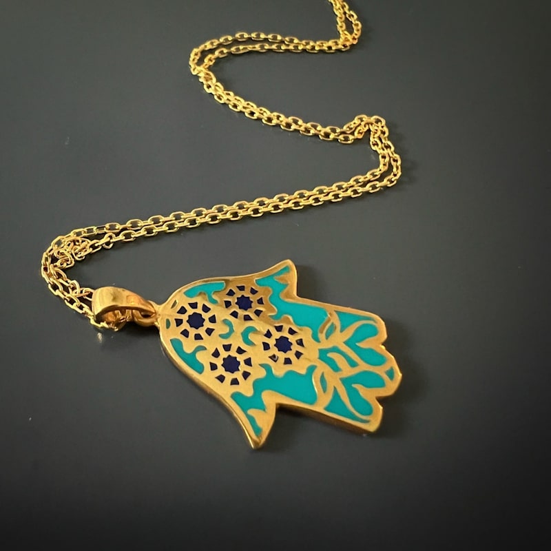 Thumbnail of Floral Hamsa Hand Pendant Turquoise & Gold Necklace - Turquoise image
