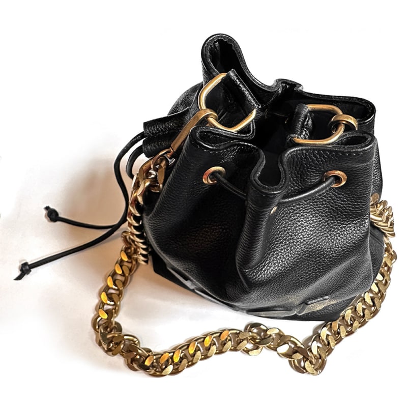 Chanel black bucket bag with logo on the front and gold detail