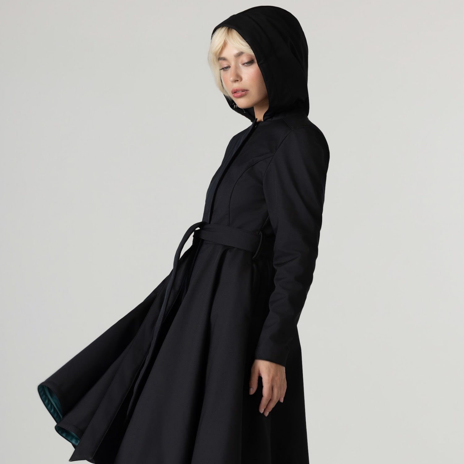 RainSisters black waterproof fit and flare coat with emerald lining and hood, swirling skirt