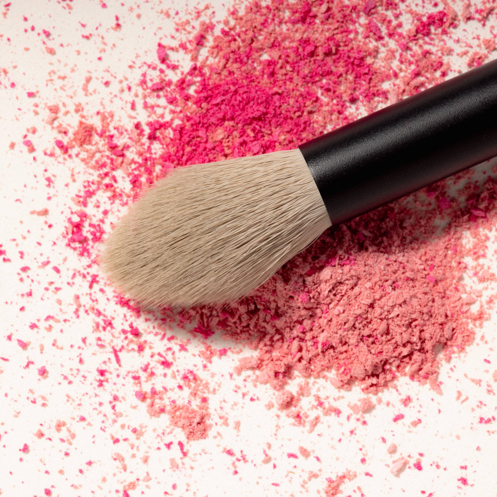Jo Leversuch Multi Use Powder Brush resting in pink powder