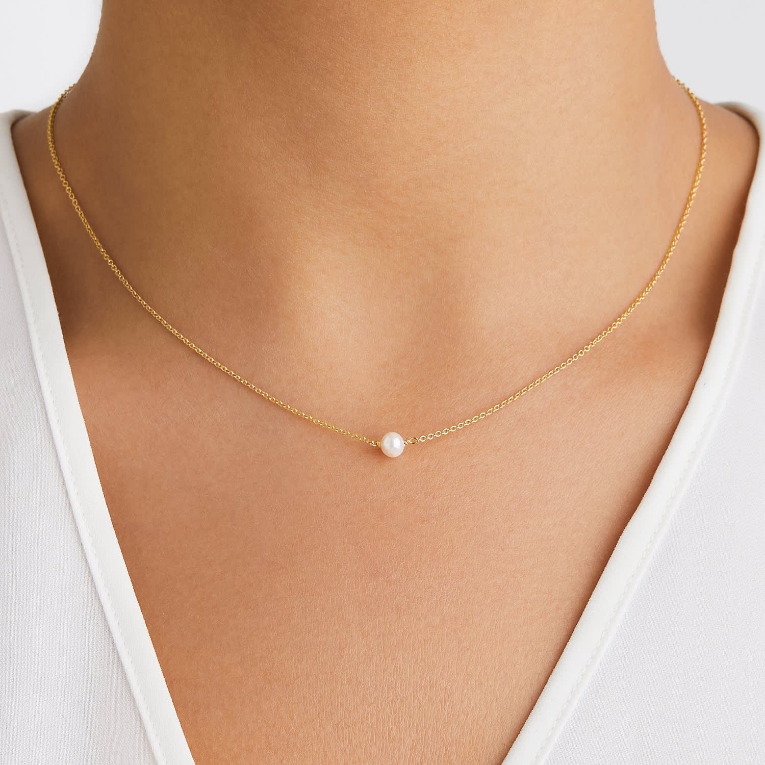 gold necklace with one pearl