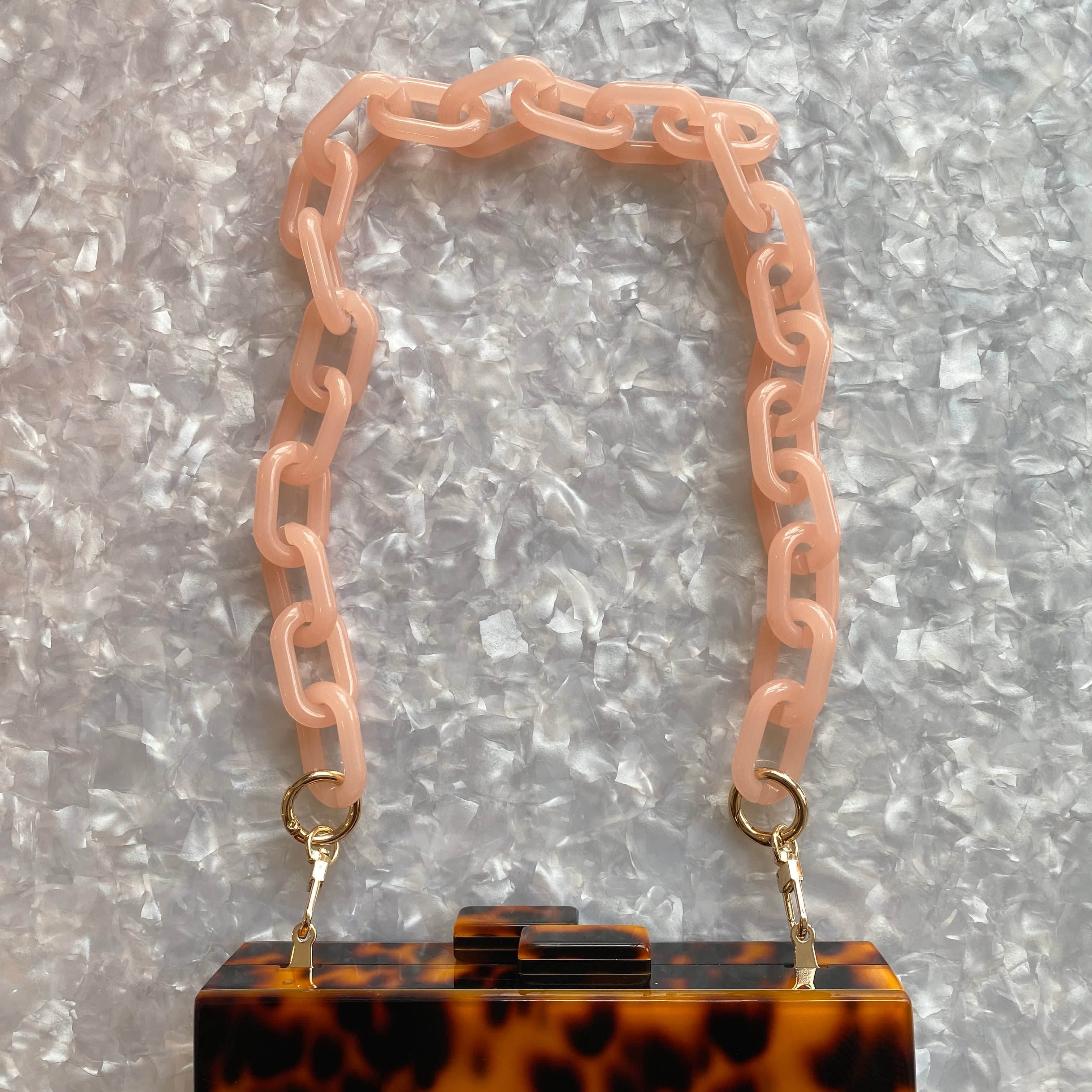 Pale pink leather and gold chain purse strap