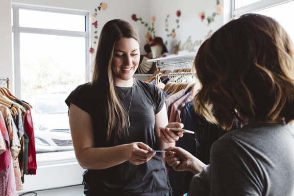 Hero image of a store owner processing a transaction