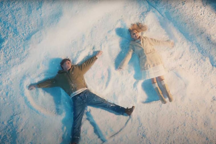 A man and woman lying in snow