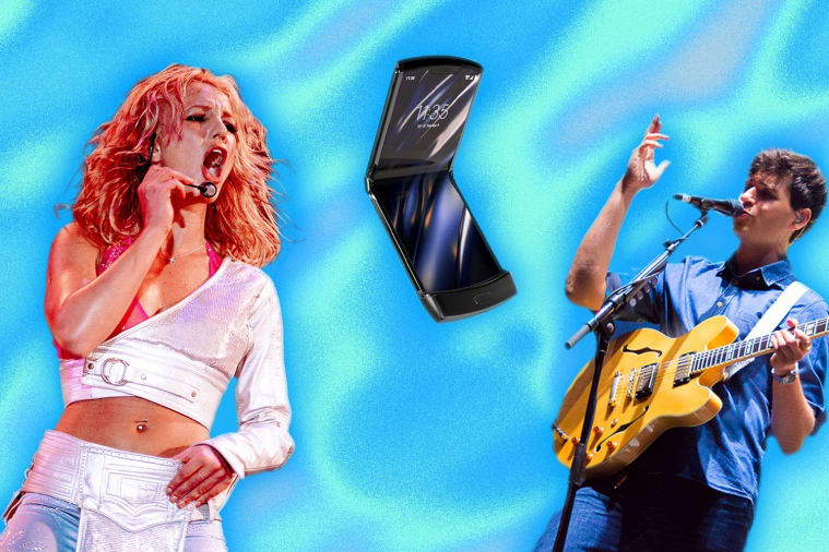 A woman singing into a microphone with a man playing guitar and a phone