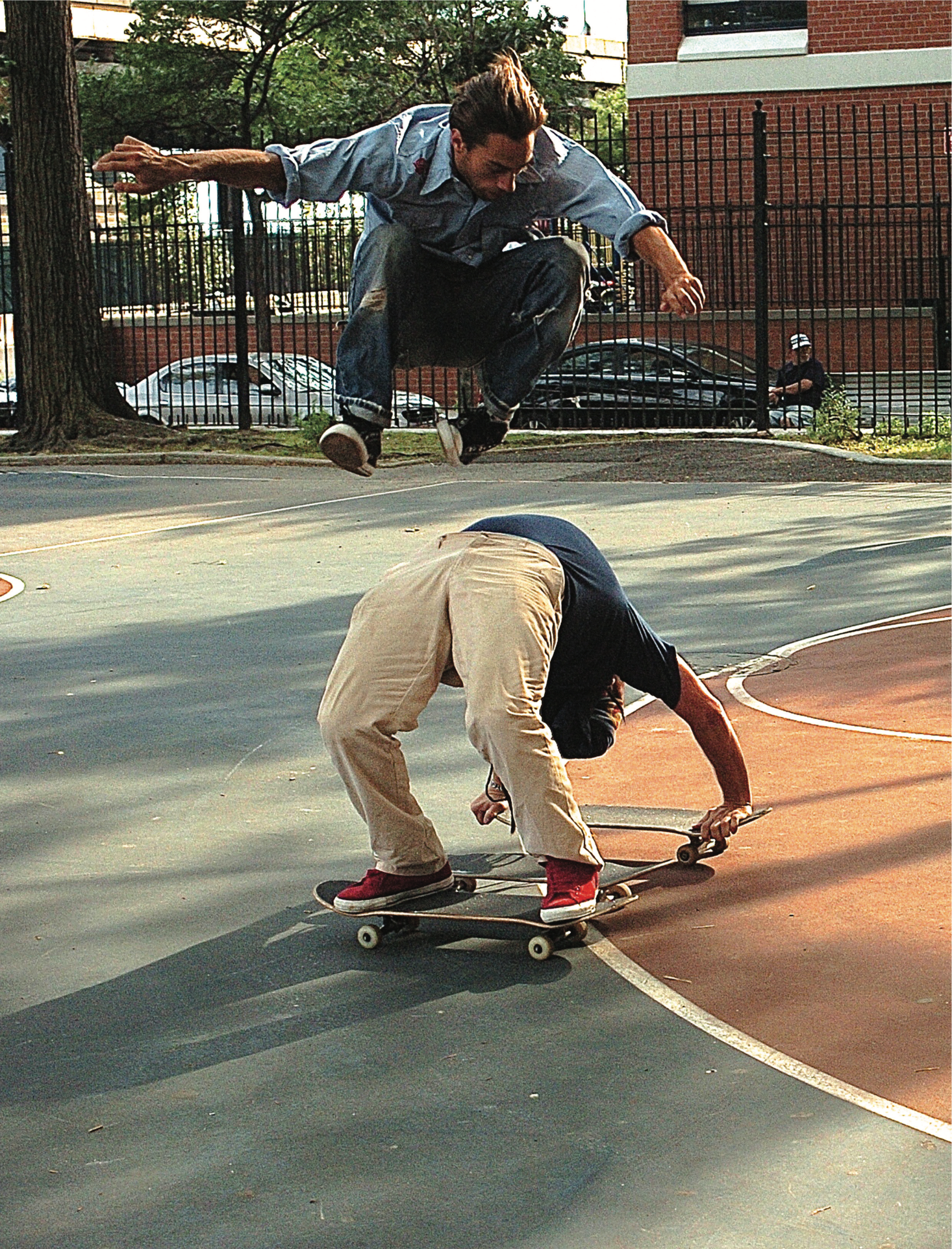 Two skateboarders ding tricks