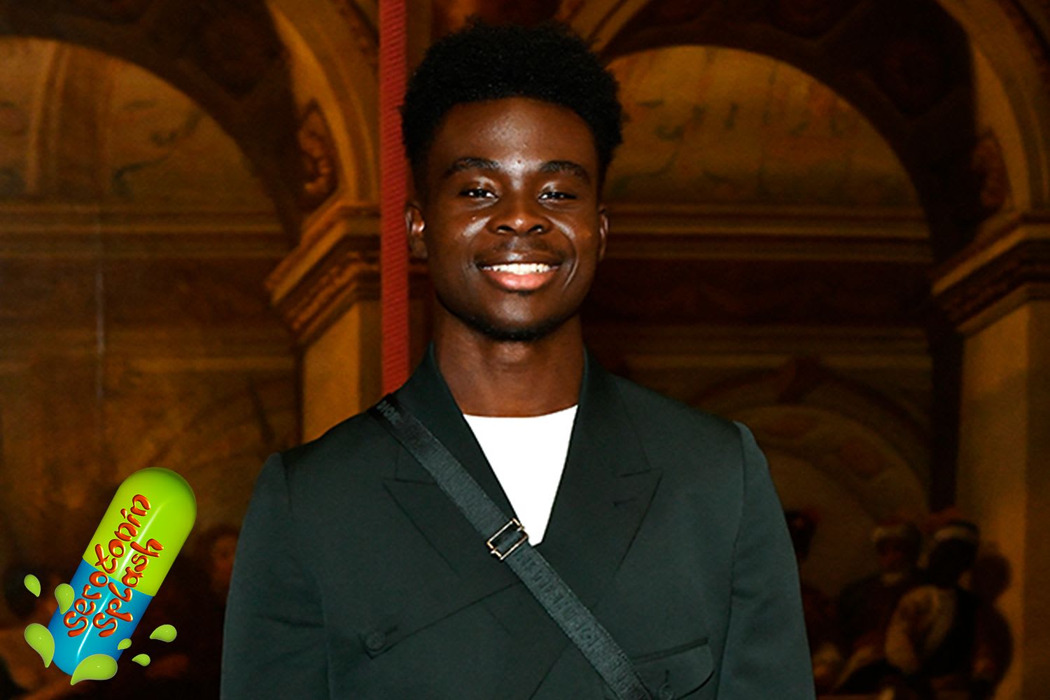 Bukayo Saka smiling in suit